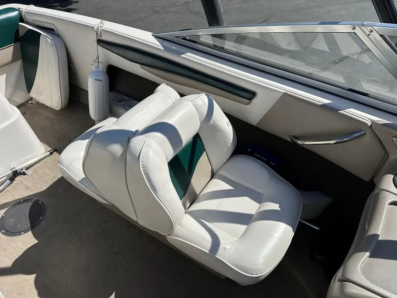 Slide: The Image of 2001 Reinell 203 boat interior with white and green seating, clean and well-maintained. - 17