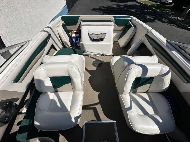 Slide: The Image of Interior of a 2001 Reinell 203 boat with white and green seating. - 18