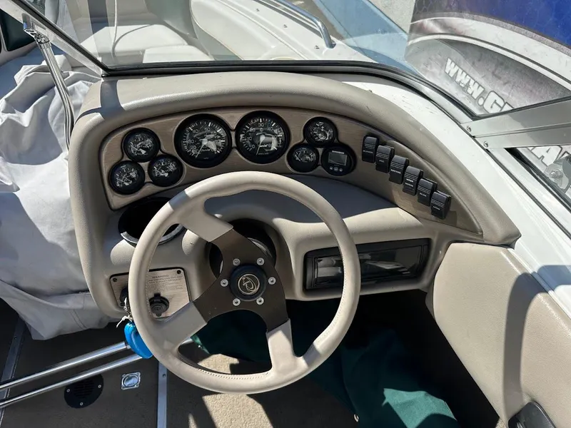 Slide: The Image of 2001 Reinell 203 boat dashboard with steering wheel and instrument panel. - 21