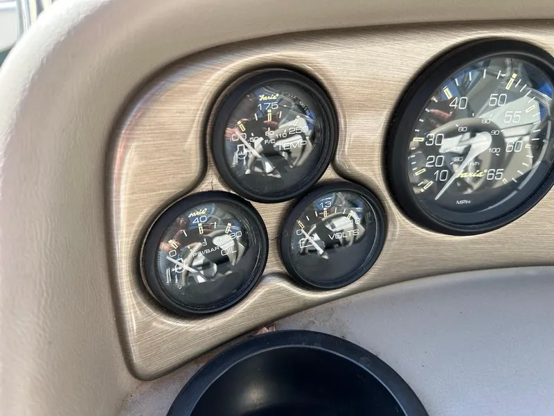 Slide: The Image of Dashboard gauges of a 2001 Reinell 203 boat, displaying speed, temperature, oil, and voltage. - 22