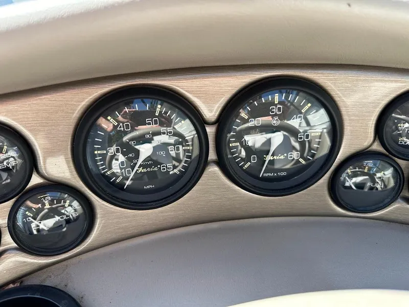 Slide: The Image of Dashboard gauges of a 2001 Reinell 203 boat, featuring speedometer and tachometer. - 23