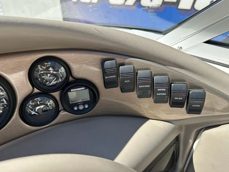 Slide: The Image of Dashboard controls of a 2001 Reinell 203 boat, featuring gauges and switches. - 24