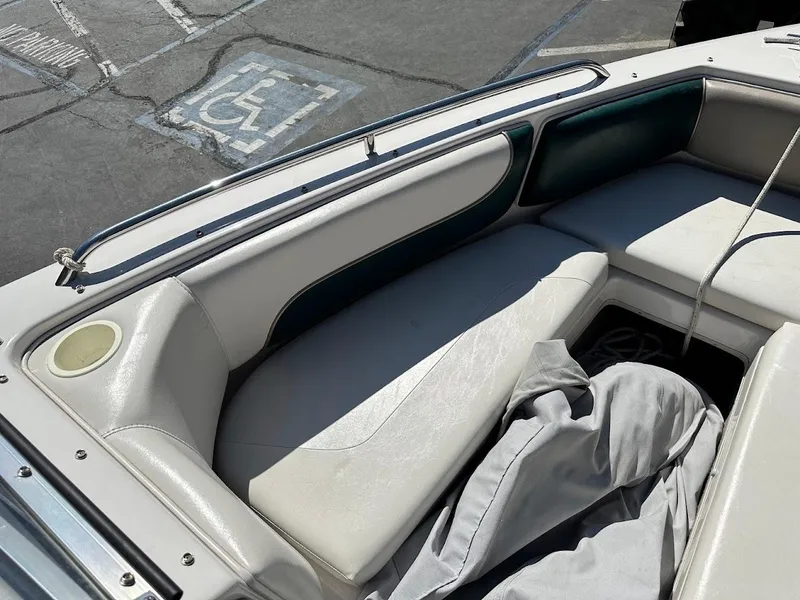 Slide: The Image of Interior of a 2001 Reinell 203 boat with white seating and storage compartment. - 29
