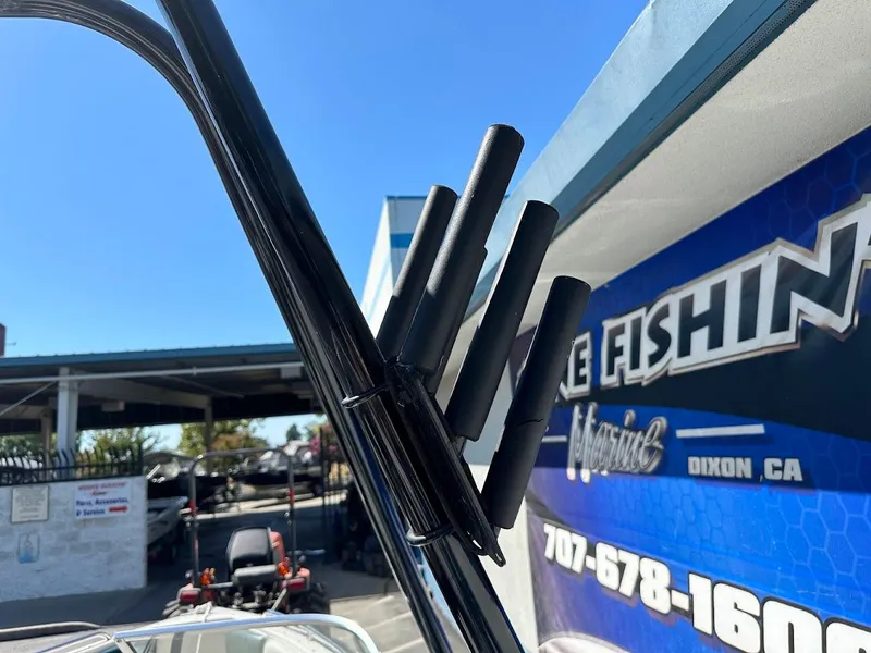 Slide: The Image of Rod holders on a 2001 Reinell 203 boat, with a blue sky background. - 31