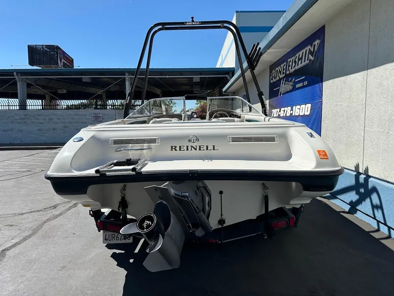 Slide: The Image of 2001 Reinell 203 boat, rear view, parked outdoors near a building. - 9