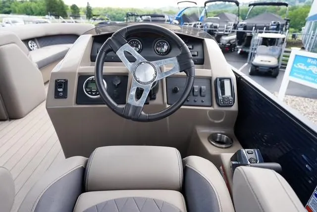 Slide: The Image of 2019 Bennington 25' Pontoon boat dashboard with steering wheel and controls. - 11