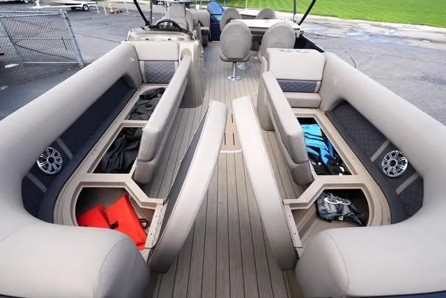 Slide: The Image of 2019 Bennington 25' Pontoon interior with open storage compartments and seating. - 9