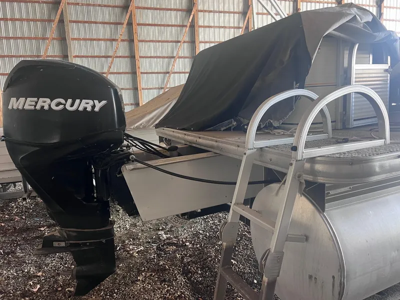 Slide: The Image of 2010 Sun Tracker PARTY BARGE 21 with Mercury outboard motor in storage. - 9