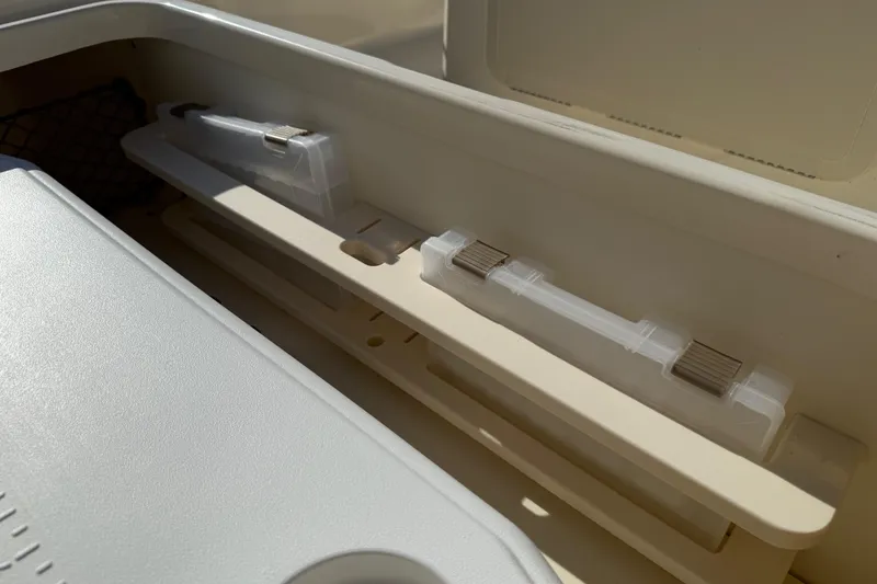 Slide: The Image of Storage compartment in 2026 Scout 177 Sport boat, featuring organized fishing gear holders. - 10