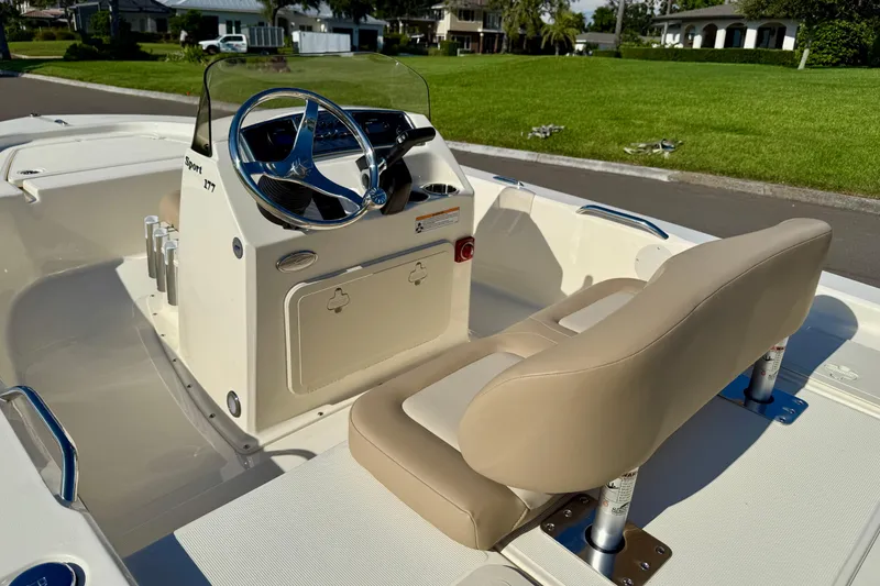 Slide: The Image of 2026 Scout 177 Sport boat interior with steering wheel and beige seating. - 12