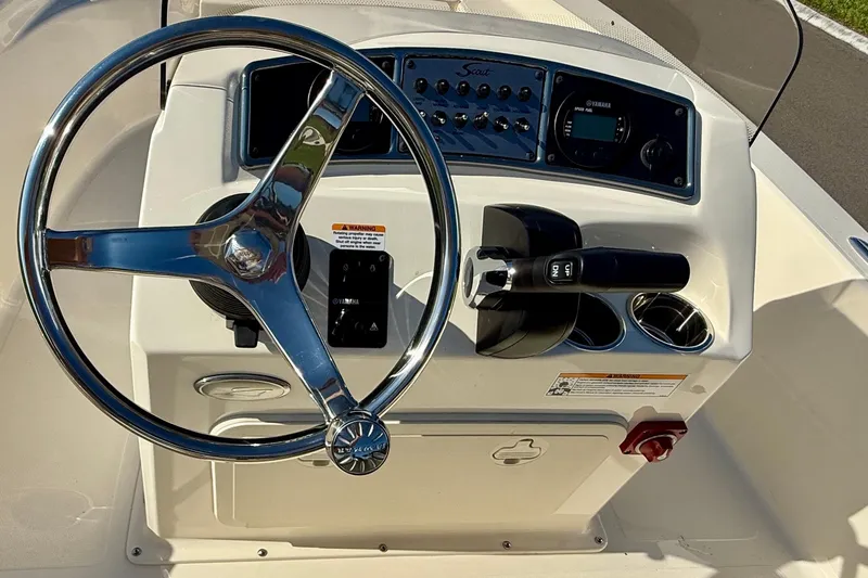 Slide: The Image of Steering console of 2026 Scout 177 Sport boat with chrome wheel and controls. - 15