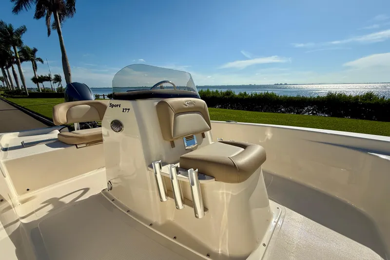 Slide: The Image of 2026 Scout 177 Sport boat with console, scenic waterfront view. - 16