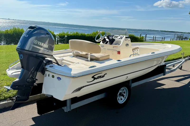 Slide: The Image of 2026 Scout 177 Sport boat with Yamaha engine on trailer by waterfront. - 2