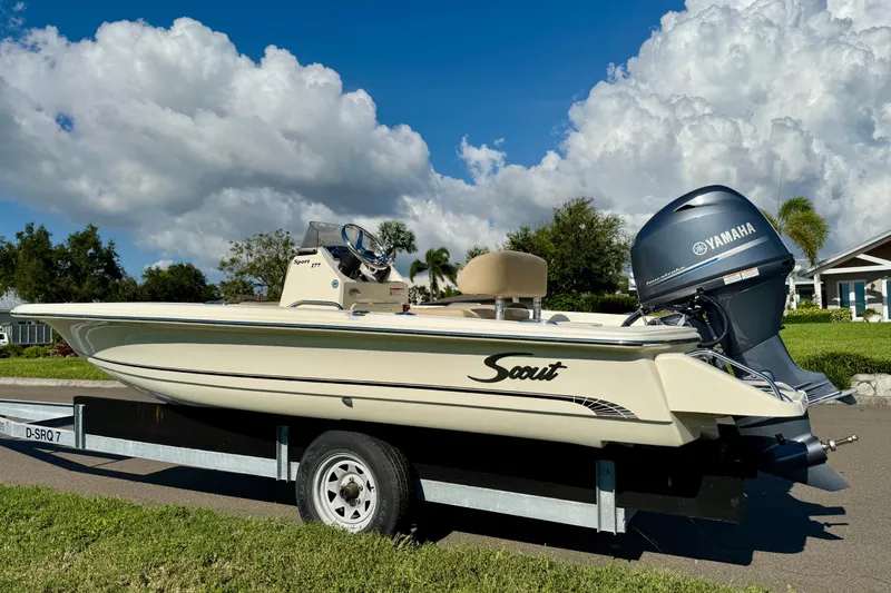 Slide: The Image of 2026 Scout 177 Sport boat on trailer with Yamaha engine, parked outdoors. - 3