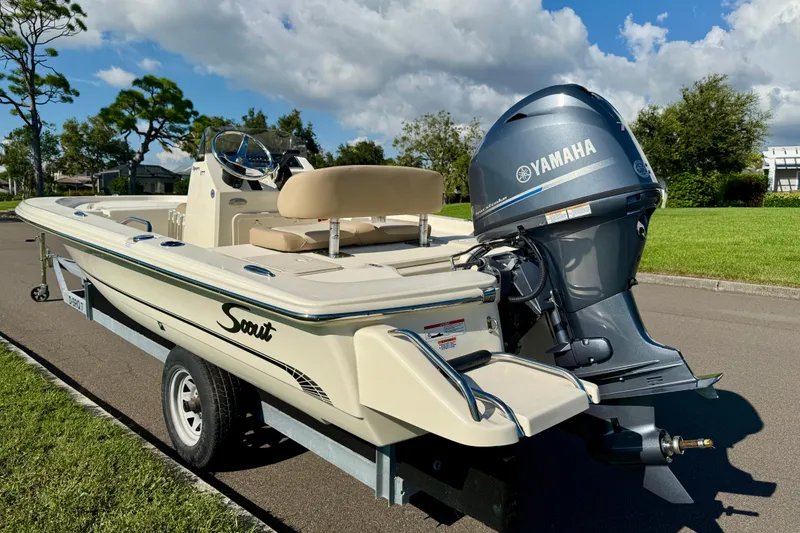 Slide: The Image of 2026 Scout 177 Sport boat with Yamaha engine on a trailer, parked on a sunny day. - 5