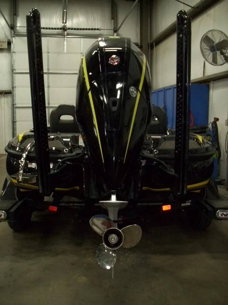 Slide: The Image of 2021 Nitro Z21 boat in garage, rear view with motor and propeller visible. - 2