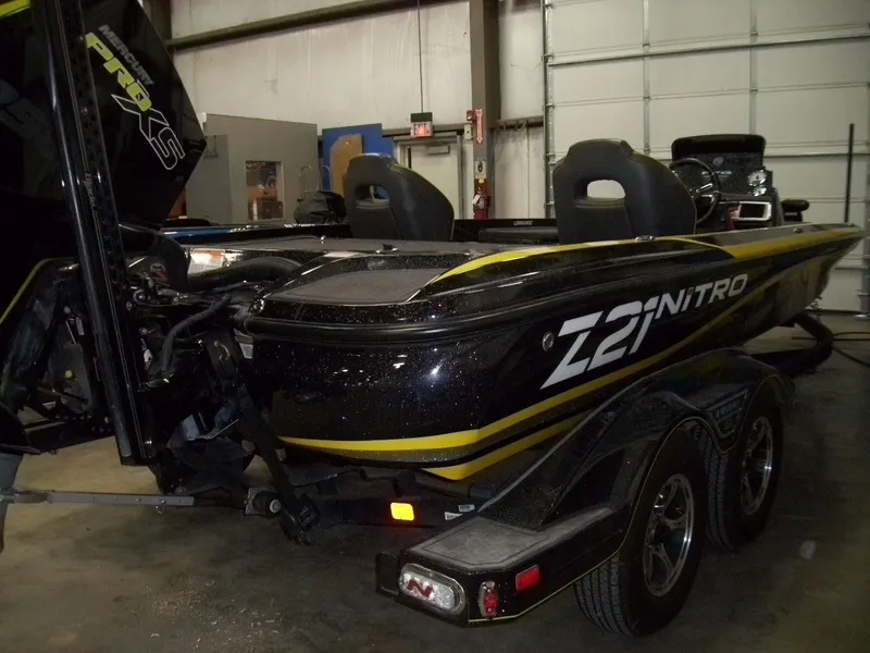 Slide: The Image of 2021 Nitro Z21 boat in a garage, featuring sleek black and yellow design. - 3