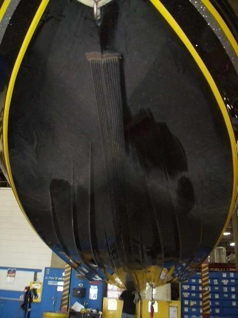 Slide: The Image of Underside view of a 2021 Nitro Z21 boat in a workshop setting. - 9