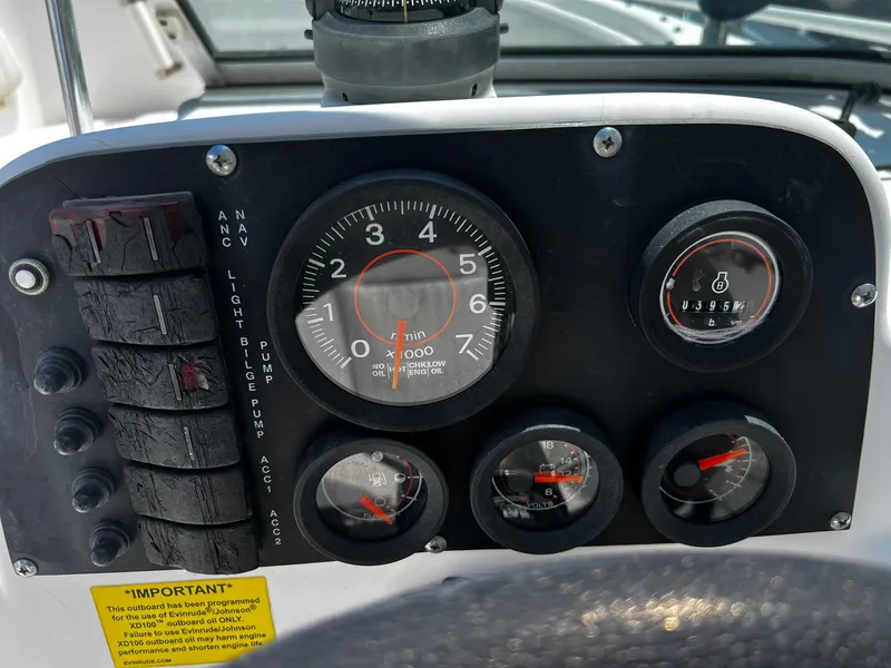 Slide: The Image of Dashboard of a 1997 Boston Whaler 20 Dauntless boat with gauges and switches. - 15