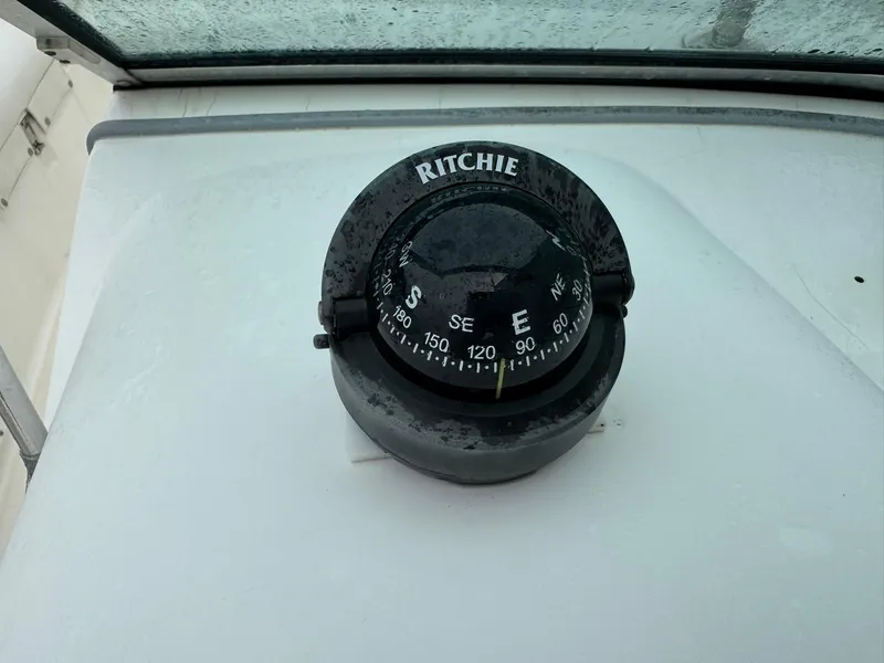 Slide: The Image of Compass on 1997 Boston Whaler 20 Dauntless boat dashboard, showing east direction. - 16