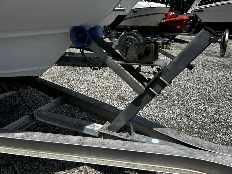 Slide: The Image of Trailer hitch of a 1997 Boston Whaler 20 Dauntless boat on gravel. - 18