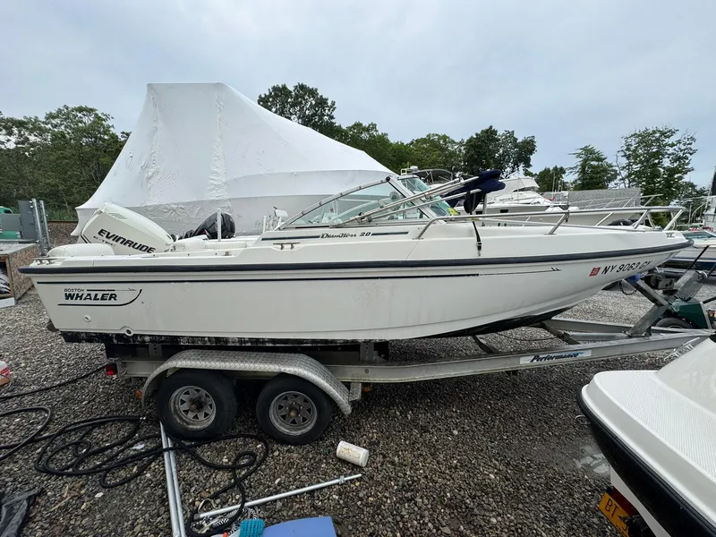 Slide: The Image of 1997 Boston Whaler 20 Dauntless boat on trailer, parked outdoors. - 2