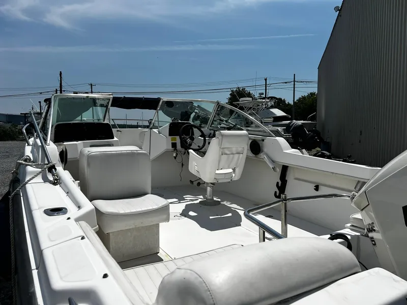 Slide: The Image of 1997 Boston Whaler 20 Dauntless boat interior with seating and steering wheel. - 6