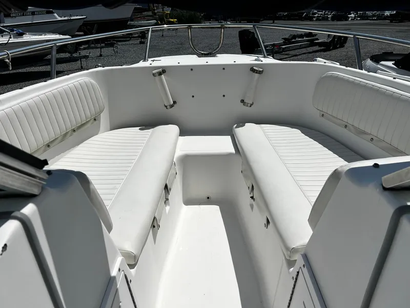 Slide: The Image of 1997 Boston Whaler 20 Dauntless boat interior with white cushioned seating. - 8