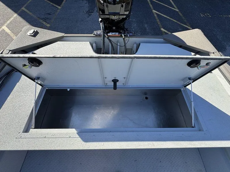 Slide: The Image of 2025 SeaArk 2072 MV Flat Cat boat storage compartment open, showing spacious interior. - 11