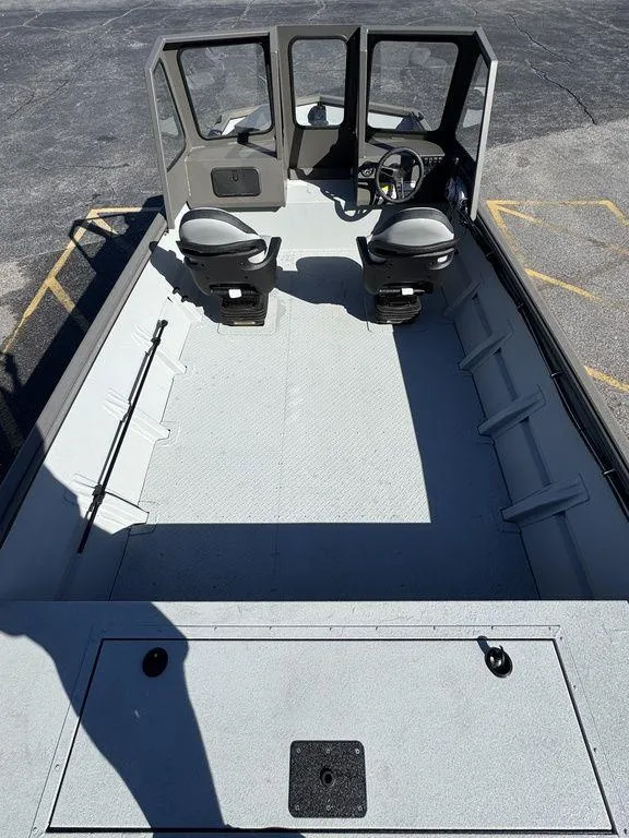 Slide: The Image of 2025 SeaArk 2072 MV Flat Cat boat interior with dual seats and steering console. - 12