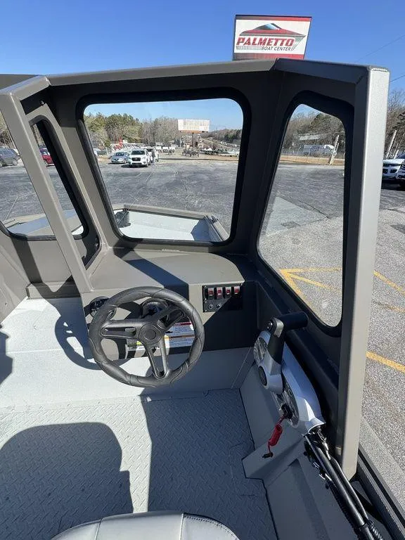 Slide: The Image of 2025 SeaArk 2072 MV Flat Cat boat interior with steering wheel and controls. - 14