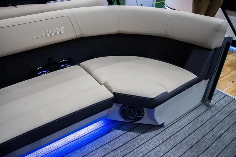 Slide: The Image of 2024 Harris Cruiser 230 boat interior with beige seating and blue LED lighting. - 12