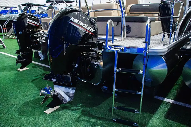 Slide: The Image of 2024 Harris Cruiser 230 pontoon boat with Mercury outboard engines and boarding ladder. - 13