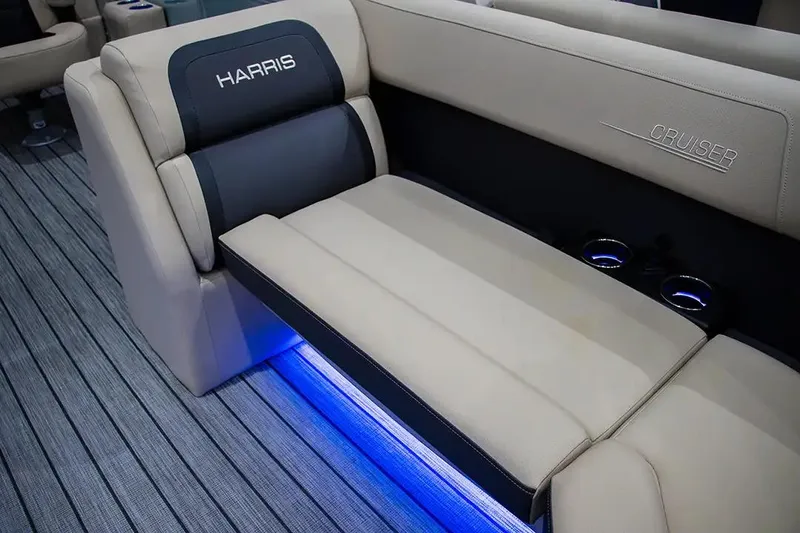 Slide: The Image of 2024 Harris Cruiser 230 boat interior with beige seating and blue LED lighting. - 14