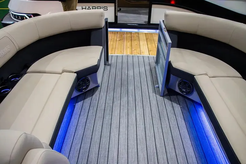 Slide: The Image of 2024 Harris Cruiser 230 interior with beige seating, blue LED lighting, and striped flooring. - 15