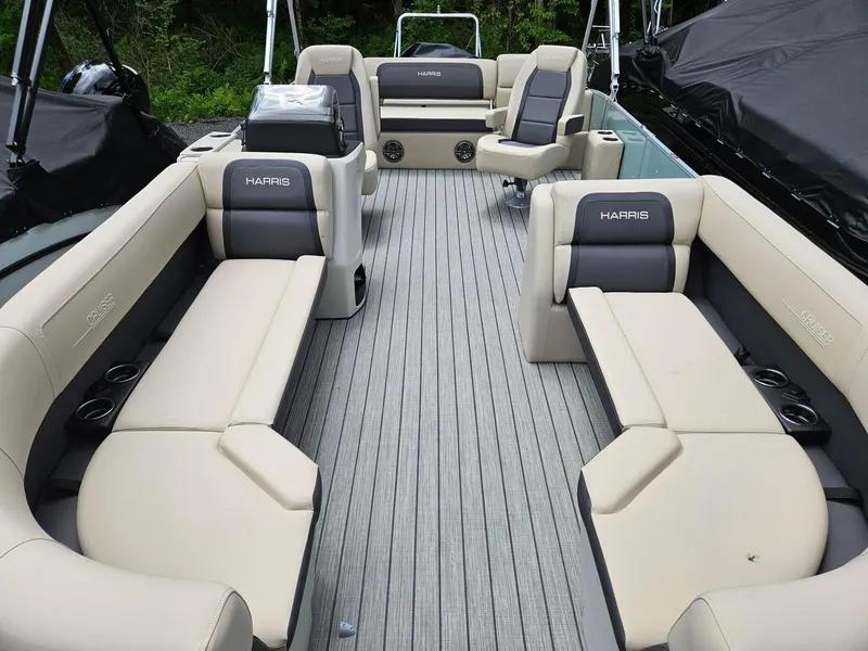 Slide: The Image of 2024 Harris Cruiser 230 boat interior with beige seating and gray flooring. - 3