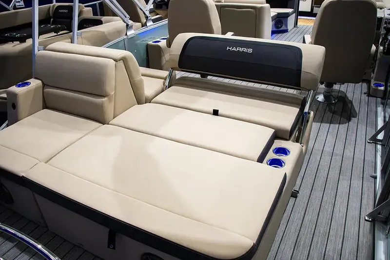 Slide: The Image of 2024 Harris Cruiser 230 boat interior with beige seating and cup holders. - 5