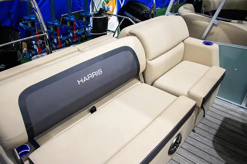 Slide: The Image of 2024 Harris Cruiser 230 boat interior with beige seating and cup holders. - 6