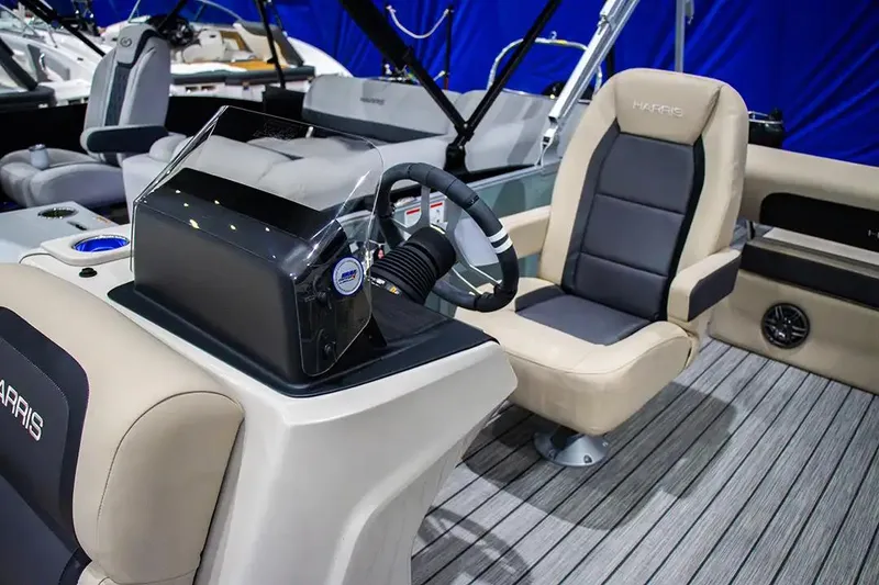 Slide: The Image of 2024 Harris Cruiser 230 boat interior with modern helm and comfortable seating. - 7