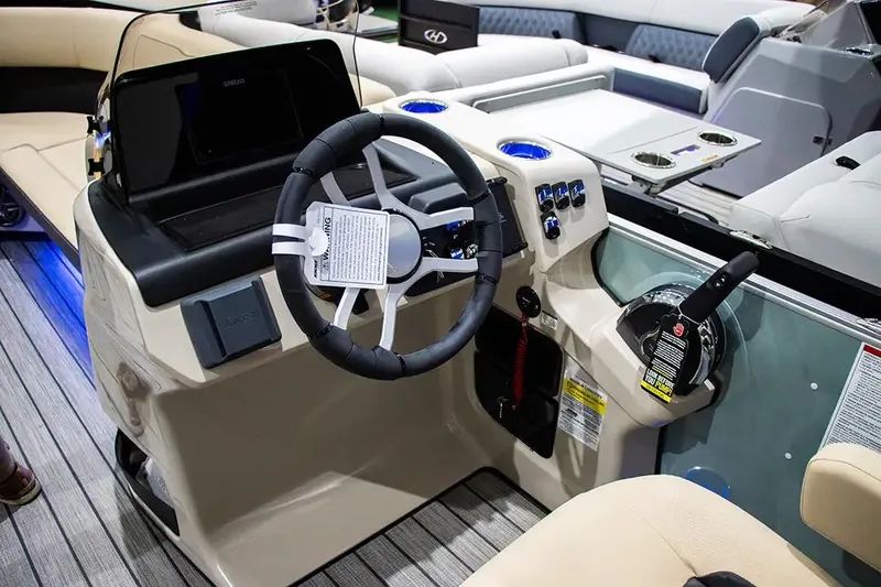 Slide: The Image of 2024 Harris Cruiser 230 boat interior with steering wheel and control panel. - 8