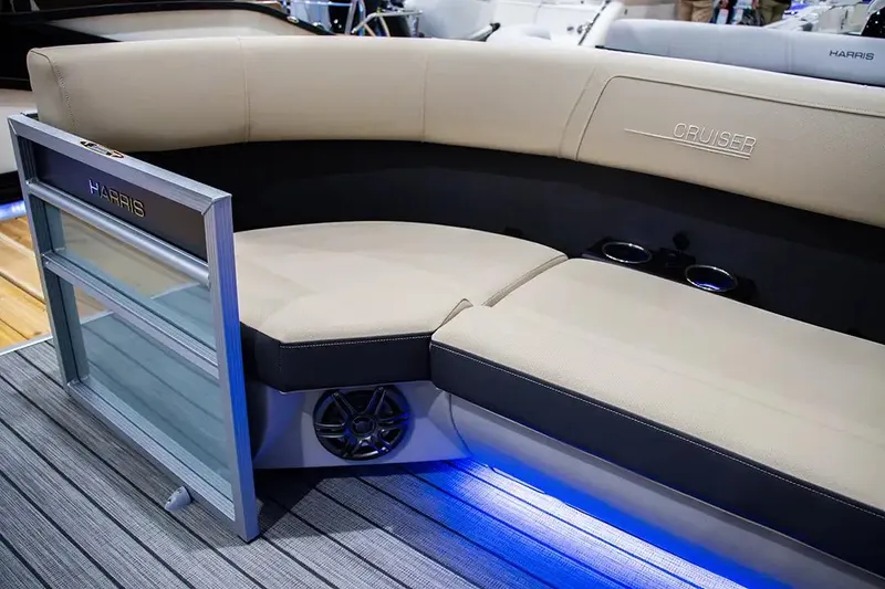 Slide: The Image of 2024 Harris Cruiser 230 boat interior with beige seating and blue LED lighting. - 9