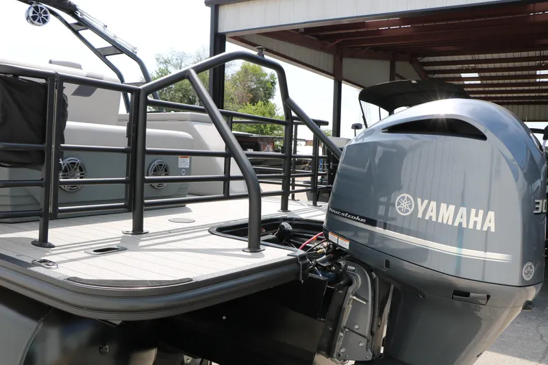 Slide: The Image of 2025 Sylvan L3 CLZ DH pontoon boat with Yamaha outboard motor in a covered dock. - 10