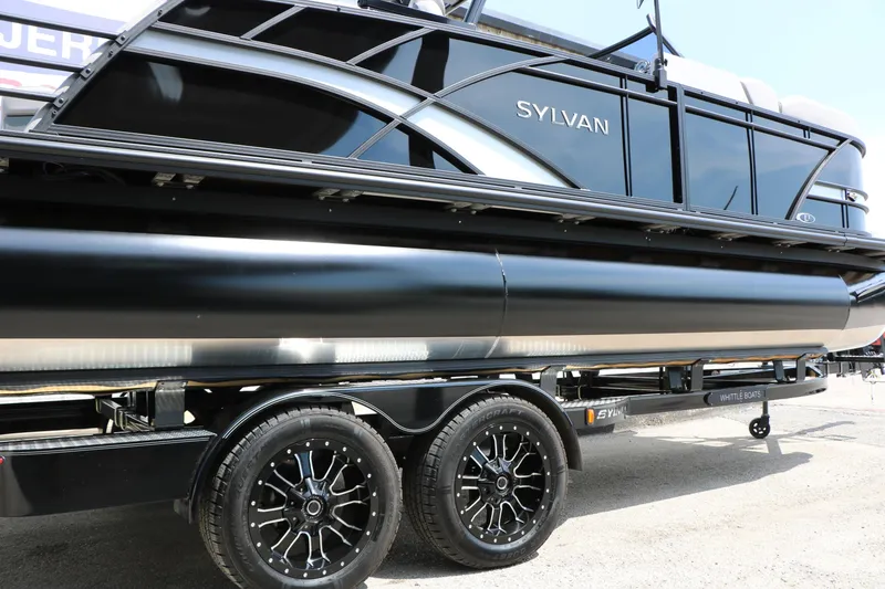 Slide: The Image of 2025 Sylvan L3 CLZ DH pontoon boat on trailer, showcasing sleek black design. - 15