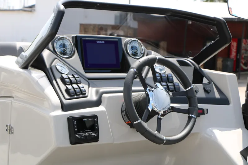 Slide: The Image of 2025 Sylvan L3 CLZ DH boat dashboard with steering wheel and control panel. - 24