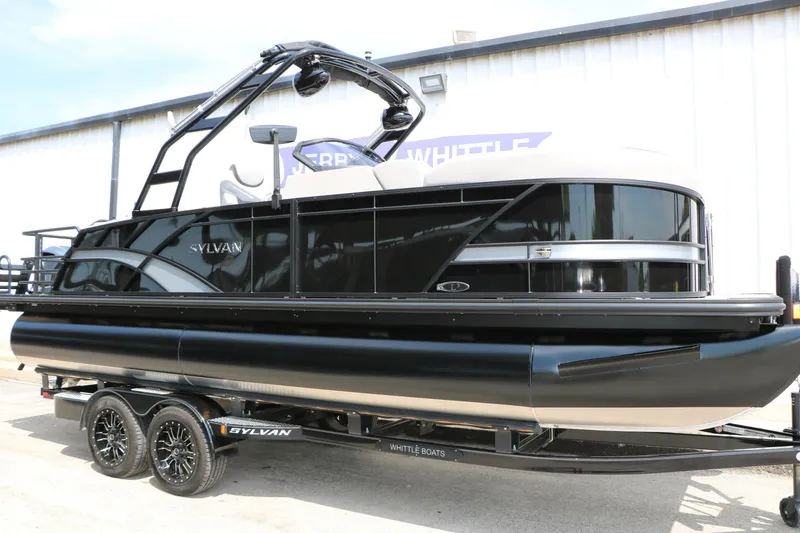 Slide: The Image of 2025 Sylvan L3 CLZ DH pontoon boat on trailer, sleek black design. - 3