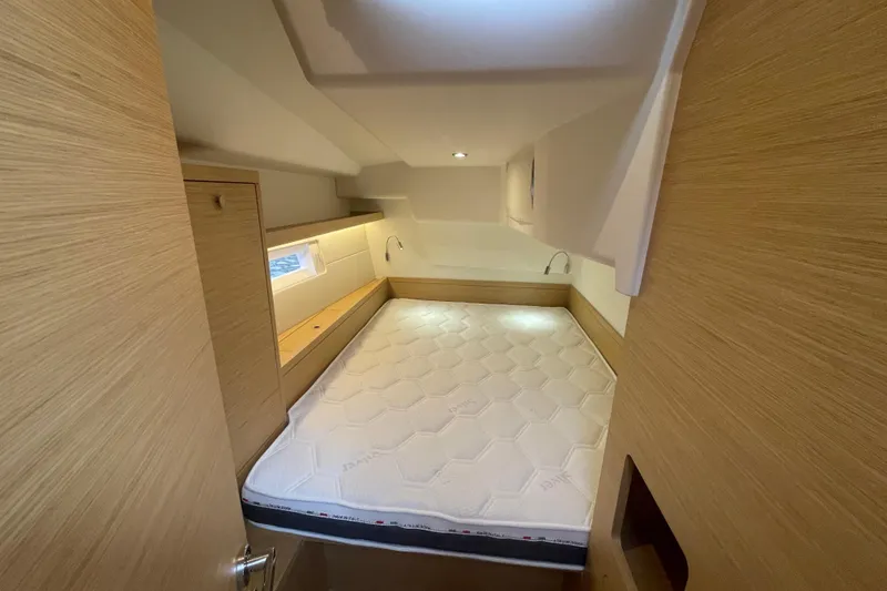 Slide: The Image of 2026 Grand Soleil 42 Long Cruise cabin with modern wood finish and cozy bed. - 22