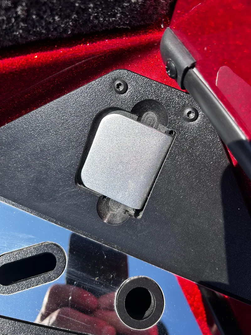 Slide: The Image of Close-up of a 2024 Ranger Z519 boat component with metallic and red details. - 13