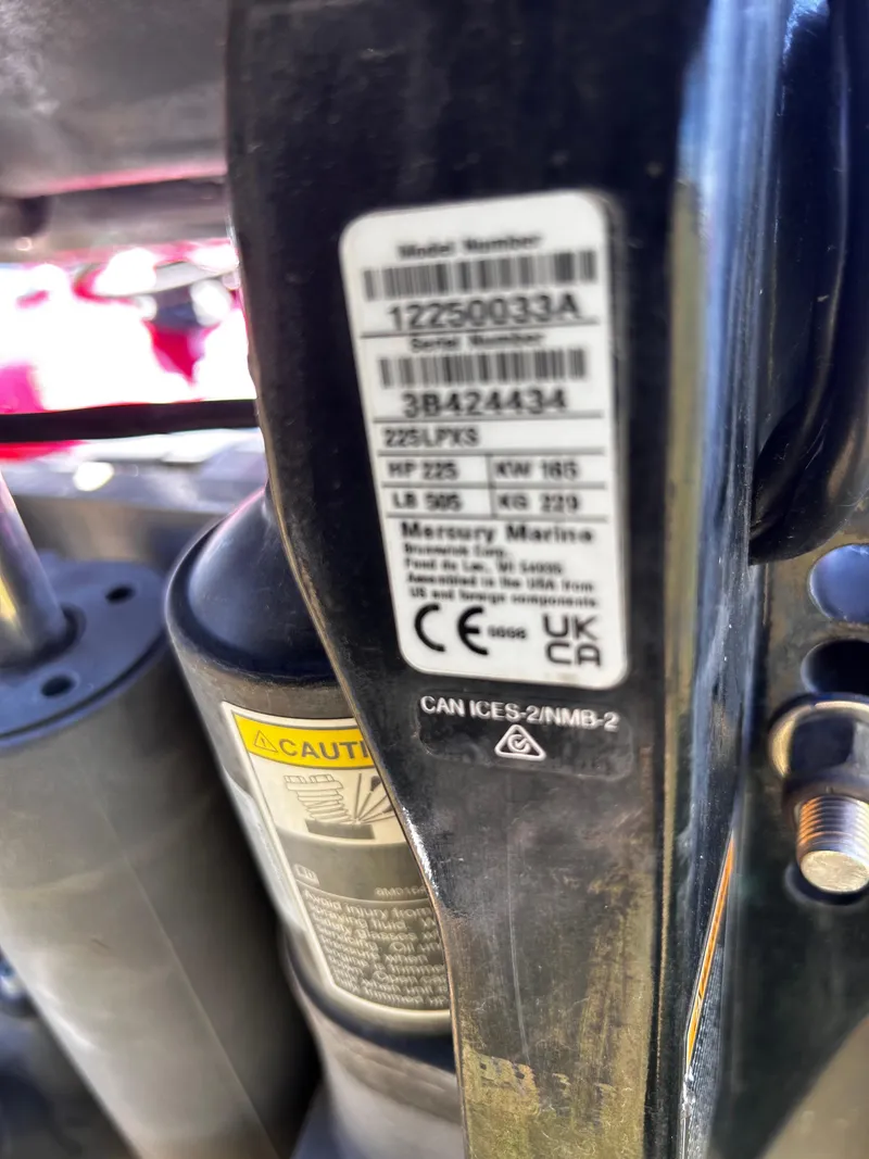 Slide: The Image of Label on 2024 Ranger Z519 boat engine, showing model and serial numbers, with caution sticker. - 16