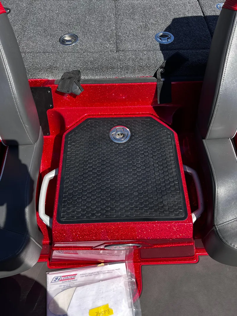 Slide: The Image of 2024 Ranger Z519 boat interior with red accents and storage compartment. - 2