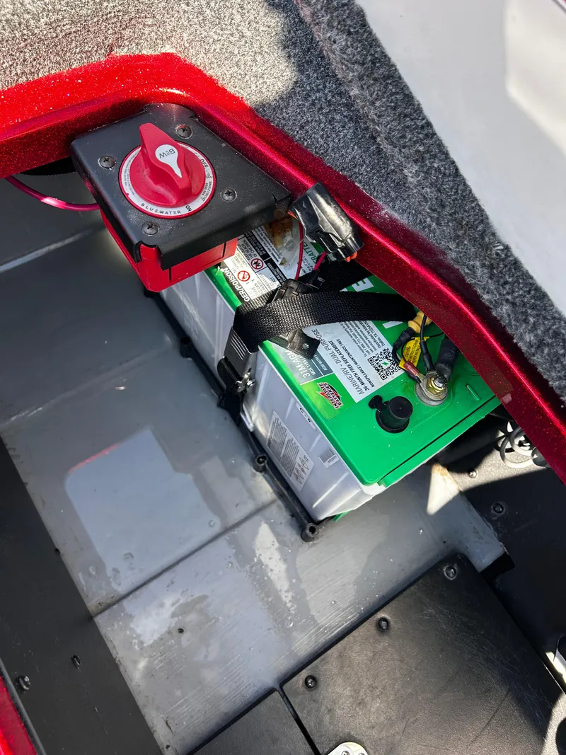 Slide: The Image of 2024 Ranger Z519 battery compartment with red power switch and secured battery. - 28